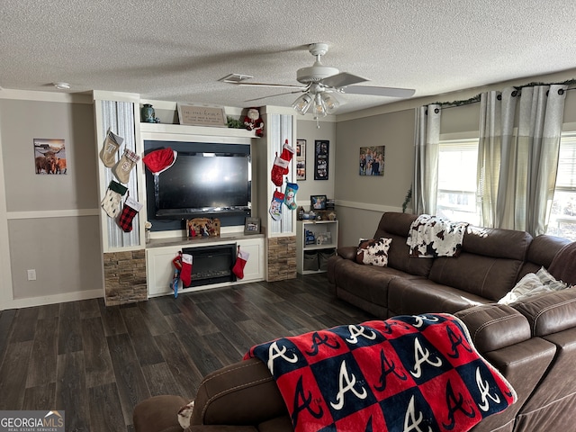 living room featuring dark hardwood / wood-style floors, ceiling fan, ornamental molding, and a textured ceiling