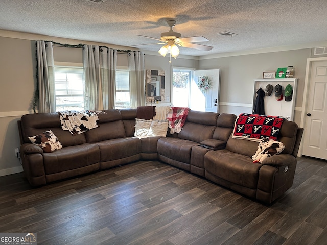 living room with a textured ceiling, dark hardwood / wood-style floors, and ceiling fan