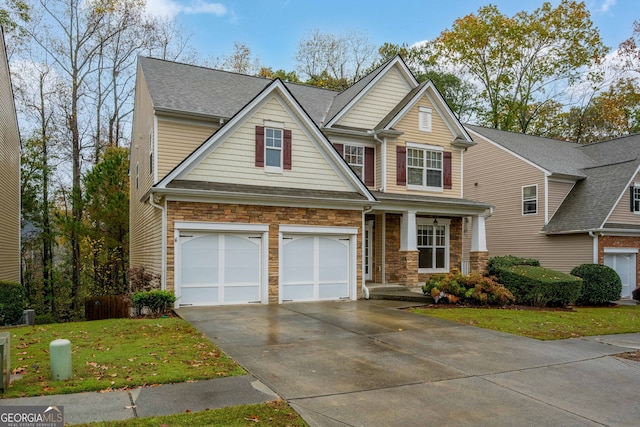 craftsman-style house featuring a garage and a front lawn