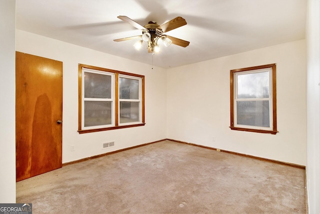 spare room with light carpet and ceiling fan