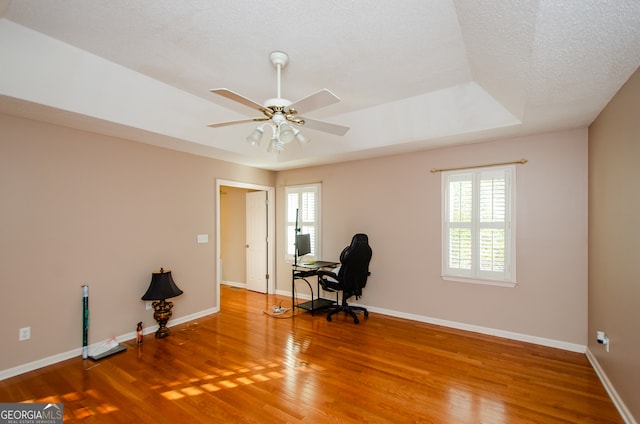 office space featuring wood-type flooring, a textured ceiling, and ceiling fan