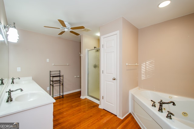 bathroom featuring hardwood / wood-style floors, ceiling fan, shower with separate bathtub, and vanity