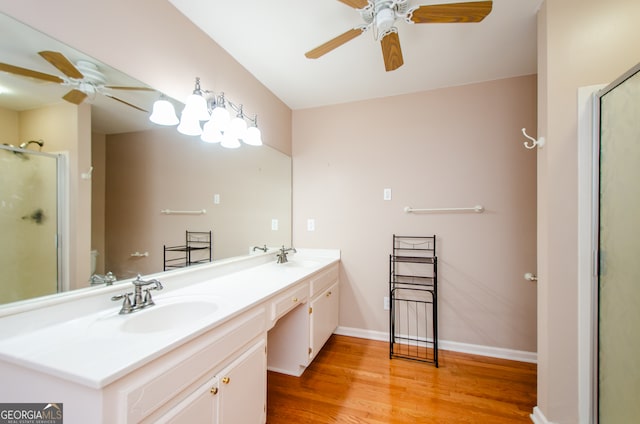 bathroom featuring hardwood / wood-style floors, vanity, an enclosed shower, and ceiling fan