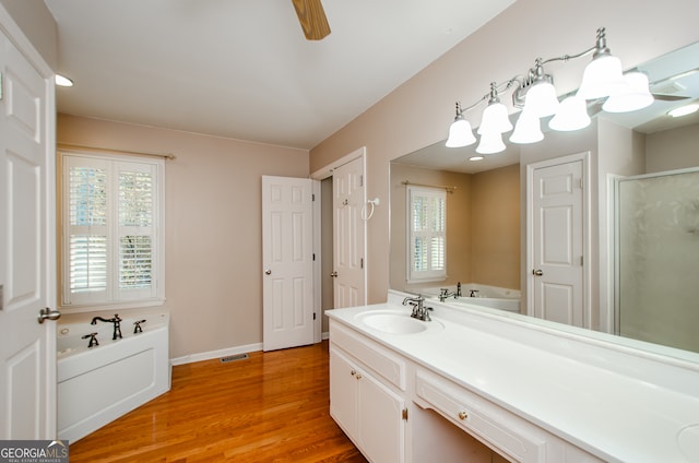 bathroom with hardwood / wood-style floors, vanity, separate shower and tub, and ceiling fan