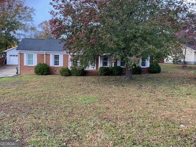 obstructed view of property featuring a garage, an outbuilding, and a front lawn