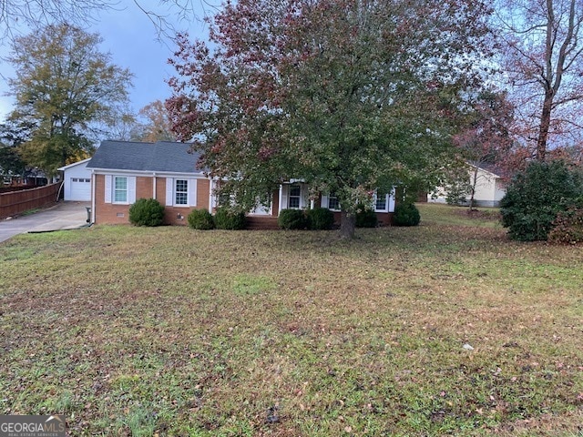 view of front of home with a front yard and a garage