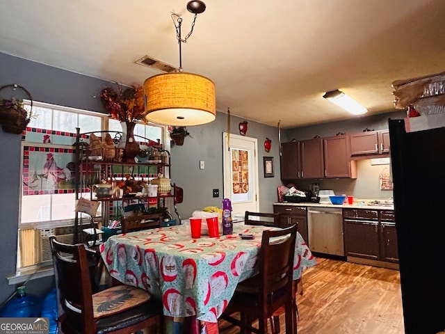 dining room with light hardwood / wood-style floors and cooling unit