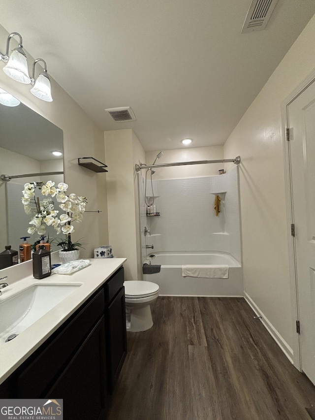 full bathroom featuring toilet, shower / bathing tub combination, wood-type flooring, and vanity