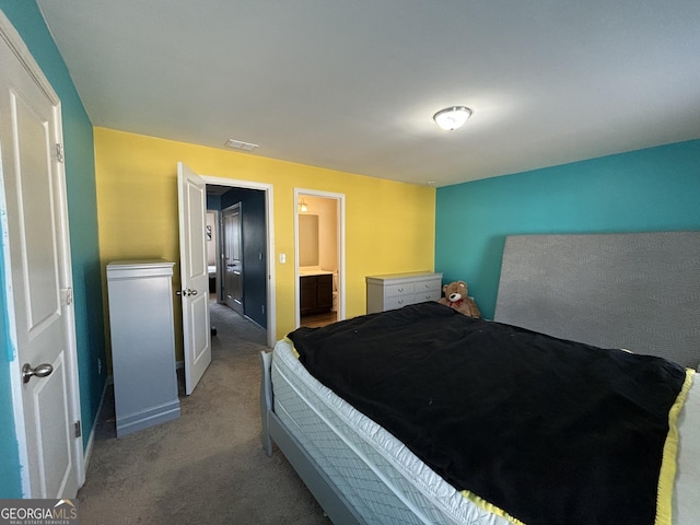 carpeted bedroom with ensuite bath