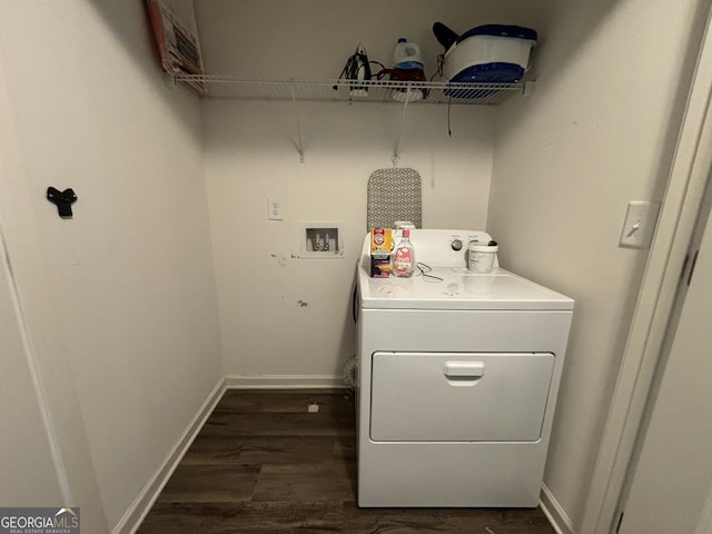 washroom with washer / dryer and dark wood-type flooring