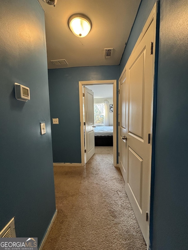 hallway featuring light carpet