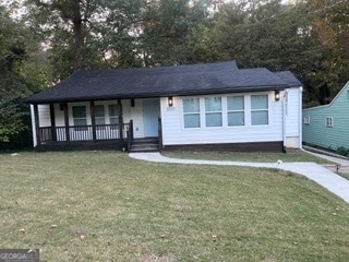 view of front of property with a front yard and a porch