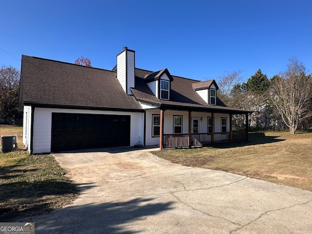 cape cod home with central air condition unit, covered porch, a front yard, and a garage