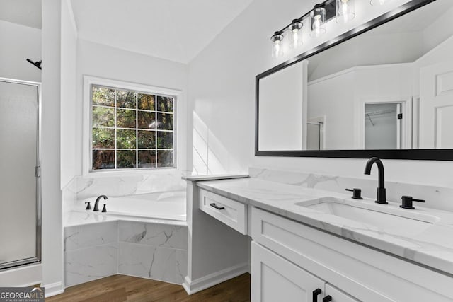 bathroom featuring separate shower and tub, vanity, and hardwood / wood-style flooring