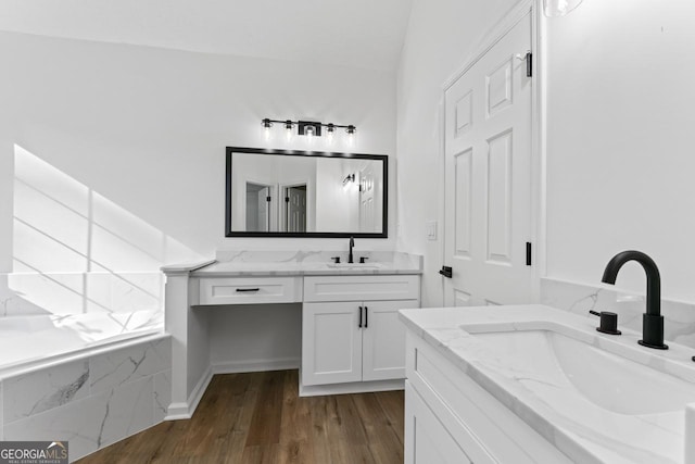 bathroom featuring vanity, lofted ceiling, and hardwood / wood-style flooring