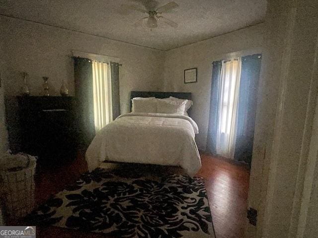 bedroom with hardwood / wood-style floors and ceiling fan