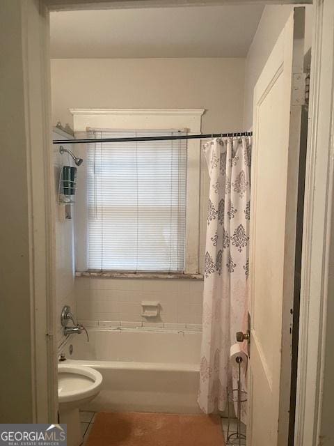 bathroom with toilet and shower / bath combo with shower curtain