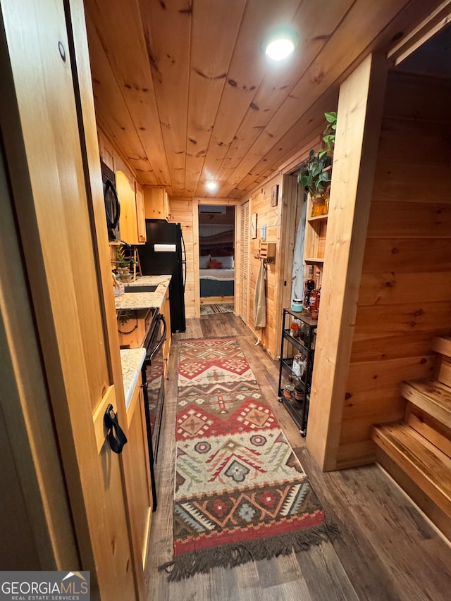 corridor with wood walls, dark hardwood / wood-style flooring, and wood ceiling