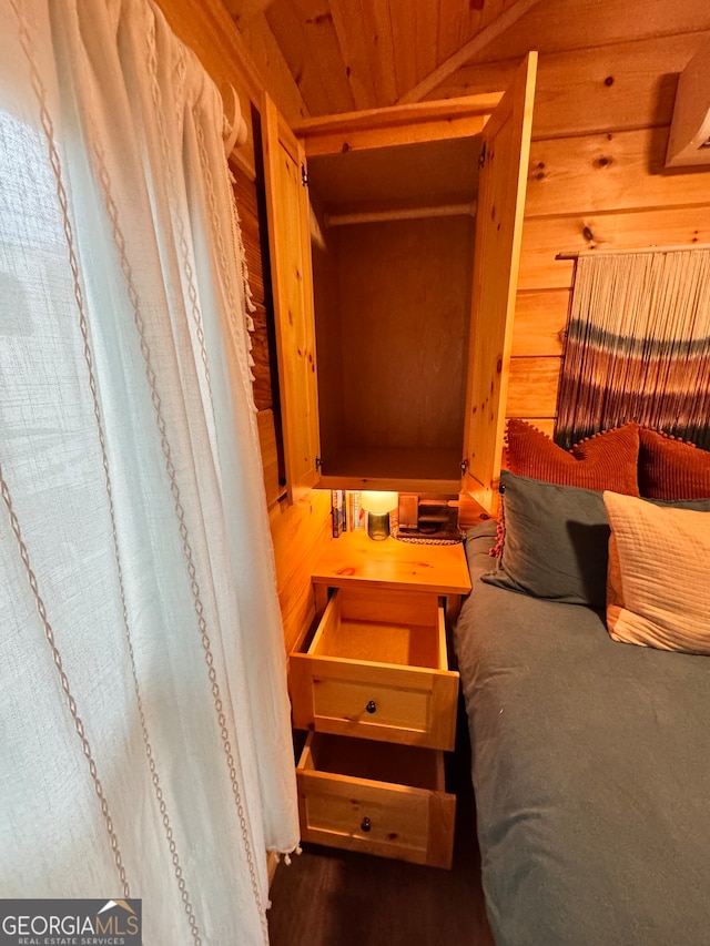 bedroom with wood ceiling and wooden walls