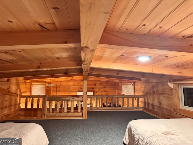 bedroom with carpet flooring, vaulted ceiling with beams, wood walls, and wood ceiling