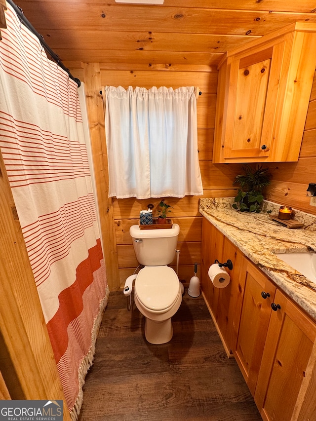 bathroom featuring vanity, wood-type flooring, wooden ceiling, toilet, and wood walls