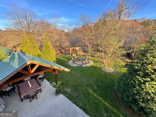 view of yard featuring a gazebo, a patio, and an outdoor fire pit