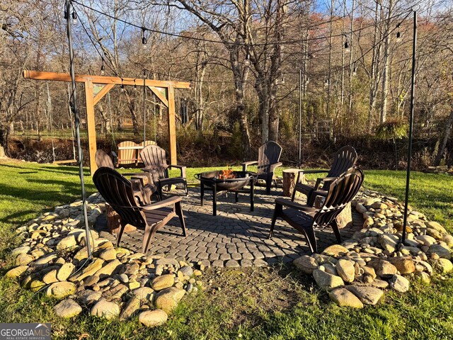 view of yard with a patio and an outdoor fire pit