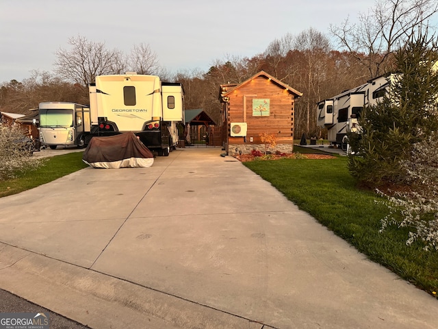 exterior space with an outdoor structure and a lawn