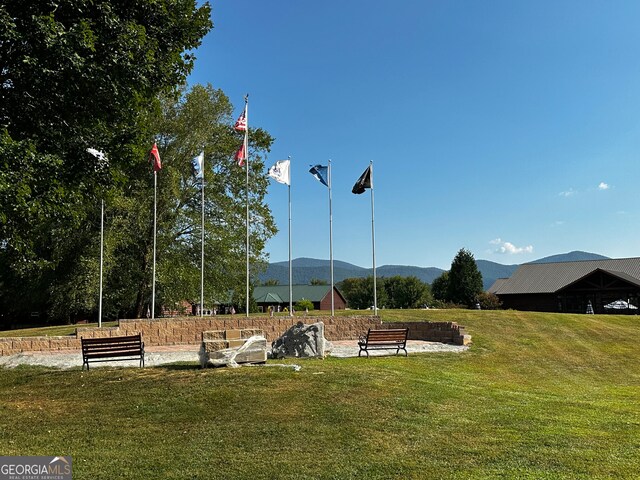 view of home's community featuring a mountain view and a lawn