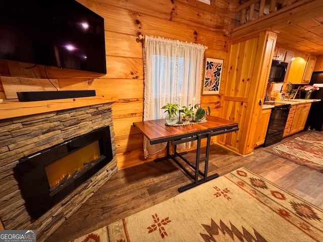 interior space with a fireplace, hardwood / wood-style floors, and wooden walls