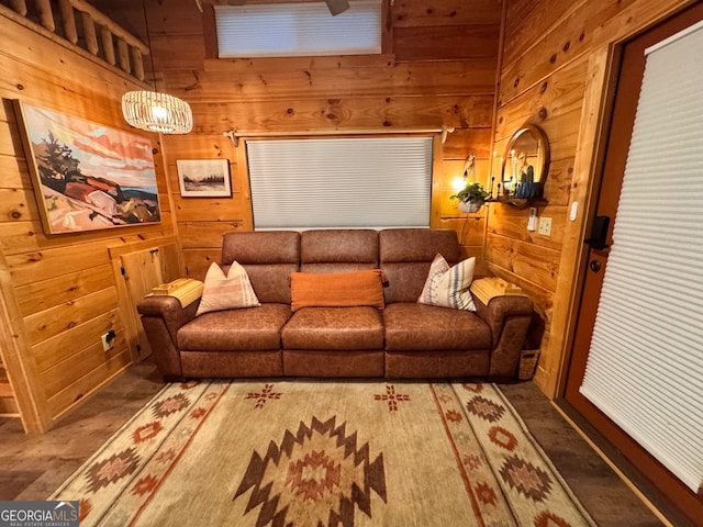 living room with a high ceiling and wooden walls