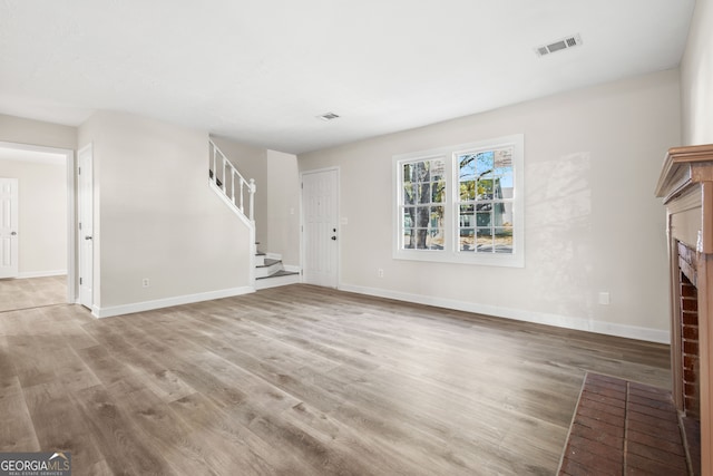 unfurnished living room with hardwood / wood-style flooring