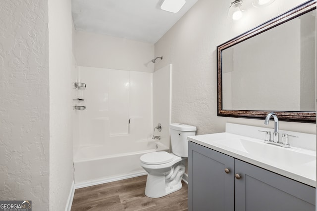 full bathroom featuring hardwood / wood-style floors, vanity, bathing tub / shower combination, and toilet