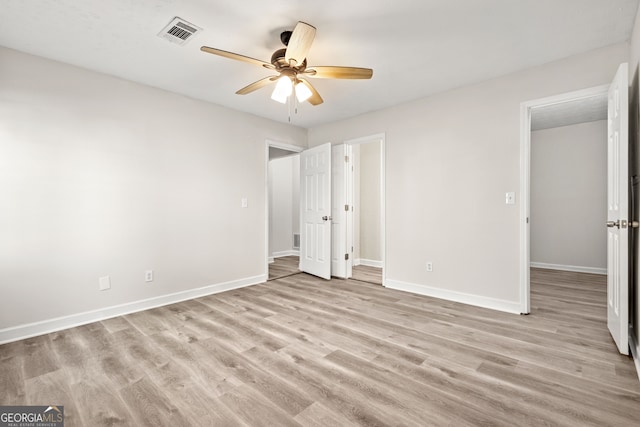 unfurnished bedroom with ceiling fan and light hardwood / wood-style floors