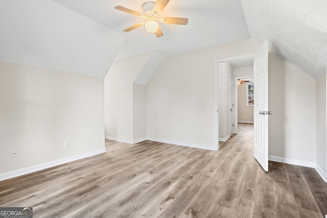 bonus room featuring ceiling fan, light hardwood / wood-style floors, and vaulted ceiling