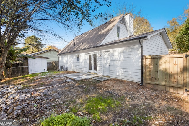 rear view of house with a patio area and central AC