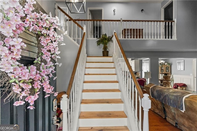 staircase with hardwood / wood-style flooring