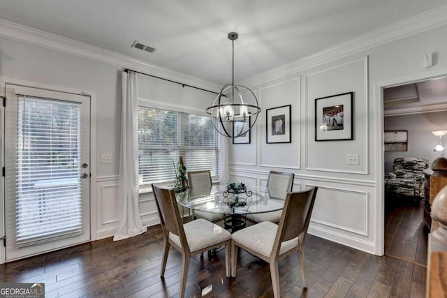 dining room featuring ornamental molding, dark wood-type flooring, and a wealth of natural light