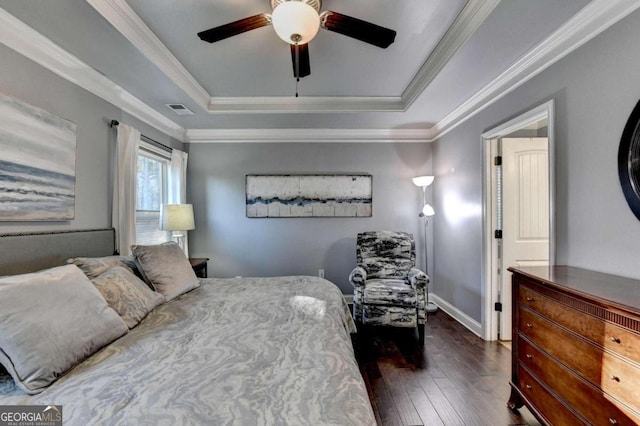 bedroom with a raised ceiling, ceiling fan, crown molding, and dark hardwood / wood-style floors