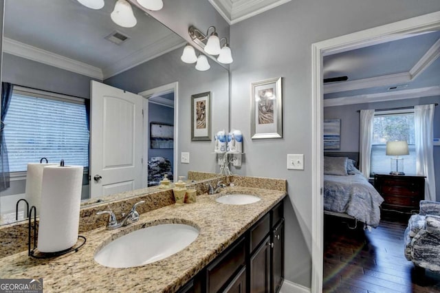 bathroom with hardwood / wood-style flooring, vanity, and ornamental molding