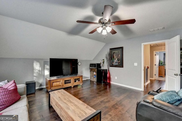 living room featuring ceiling fan, lofted ceiling, and dark wood-type flooring