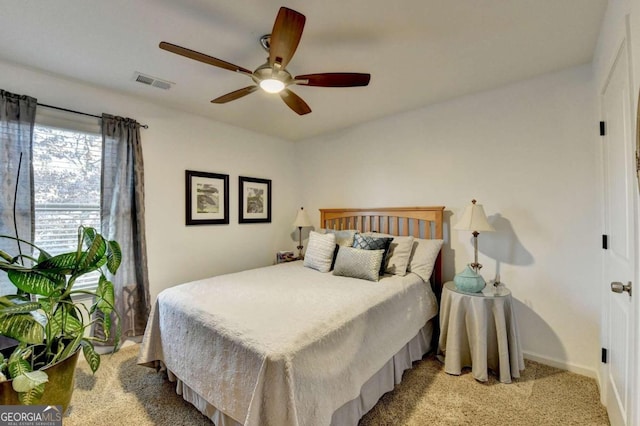 bedroom featuring light colored carpet and ceiling fan