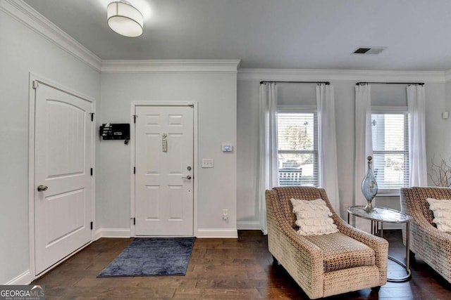 entrance foyer with dark hardwood / wood-style flooring and crown molding