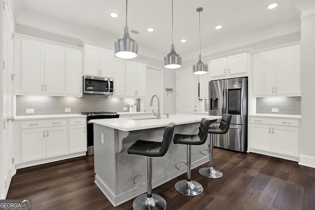 kitchen with white cabinetry, pendant lighting, dark hardwood / wood-style floors, and appliances with stainless steel finishes