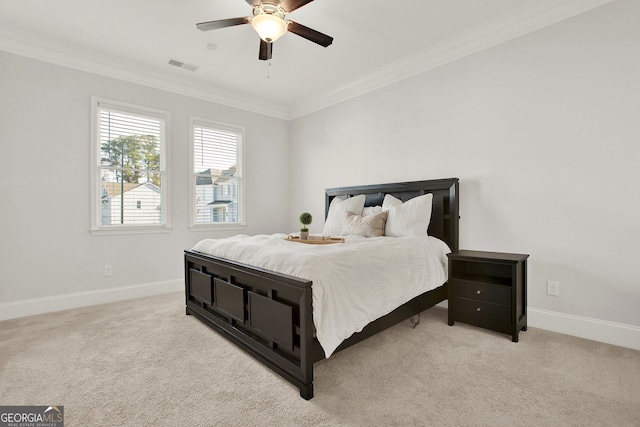 carpeted bedroom with ceiling fan and ornamental molding