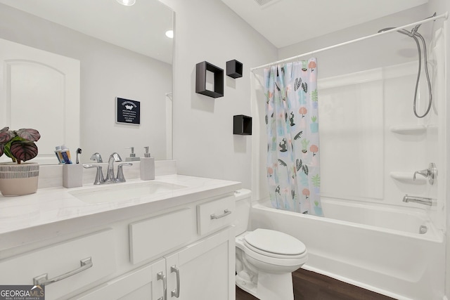 full bathroom with hardwood / wood-style floors, vanity, shower / bath combo, and toilet