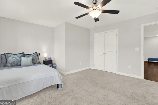 carpeted bedroom featuring a closet and ceiling fan