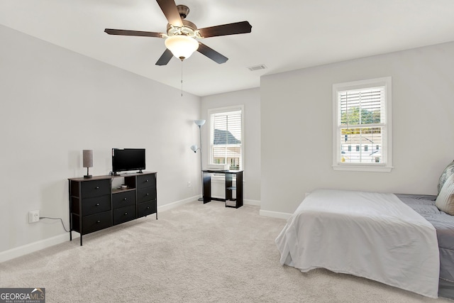 bedroom with light carpet and ceiling fan