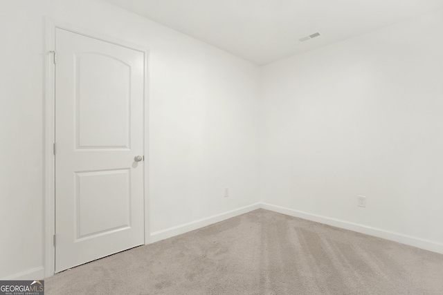 spare room with light carpet