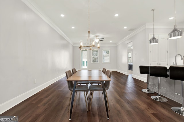 dining room with dark hardwood / wood-style floors, ceiling fan, ornamental molding, and sink